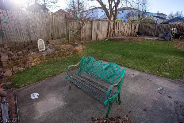 a wooden bench sitting in the middle of a yard