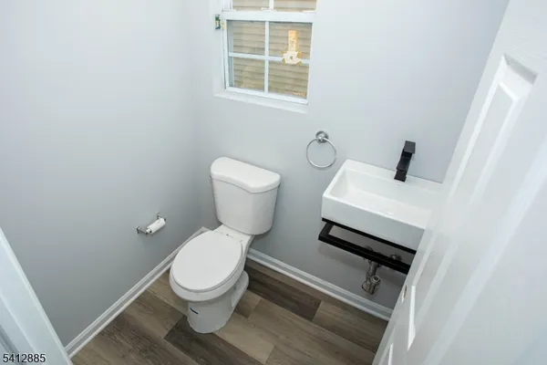 a white toilet sitting next to a bathroom sink