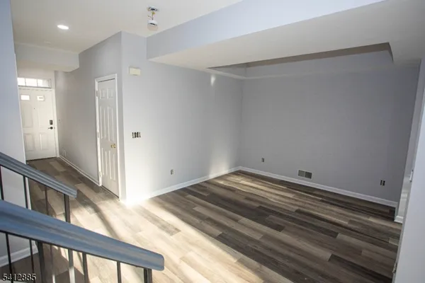 a view of a room with wooden floor and a sink