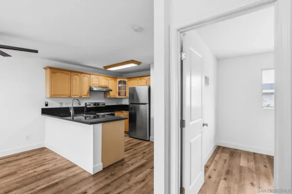 a kitchen with granite countertop a sink and a stove top oven