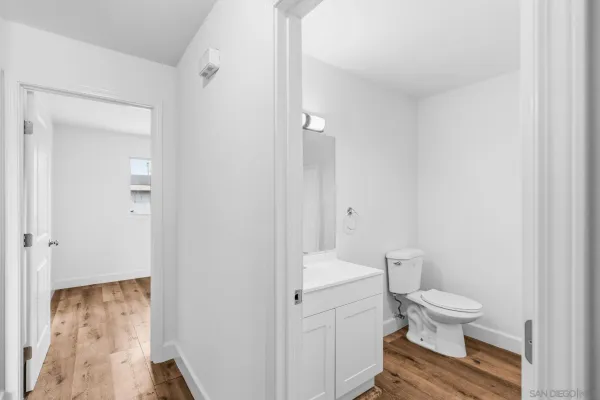 a white toilet sitting next to a bathroom sink