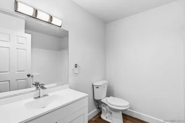 a bathroom with a sink toilet and a mirror