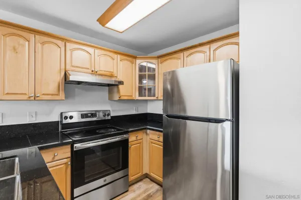 a white refrigerator freezer sitting in a kitchen