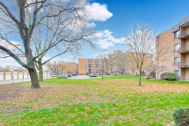 a backyard of a house with lots of green space and fountain