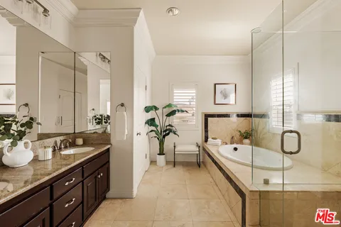 a spacious bathroom with a double vanity sink mirror and double