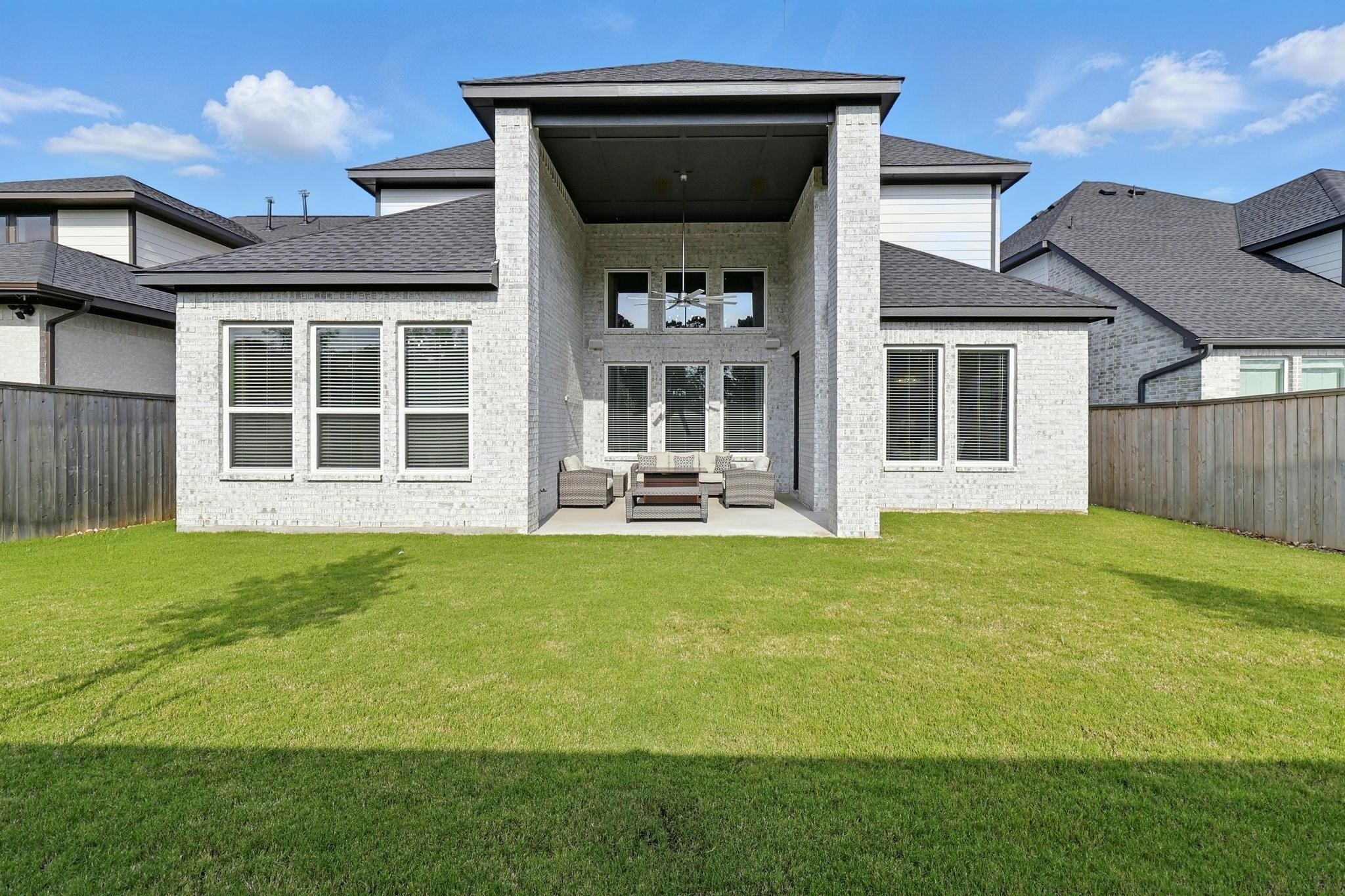 26923 Arethusa Court Spring, TX 77389 - Photo 2 of 44 This modern two-story home with spacious backyard. The exterior features light brick and multiple large windows, offering an abundance of natural light. A covered patio area provides a cozy outdoor space for relaxation or entertaining.