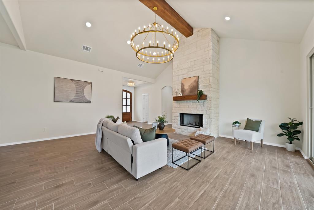 501 Harris Road Azle, TX 76020 - Photo 6 of 29 a living room with furniture a fireplace and a table
