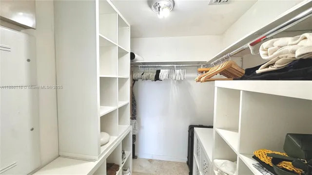 a spacious bedroom with a bed and a large window