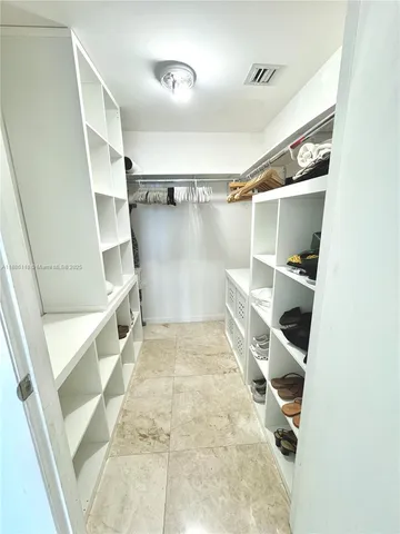 a bedroom with a bed and a chair with the outer view