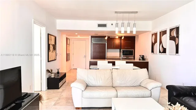 a living room with furniture and wall paintings