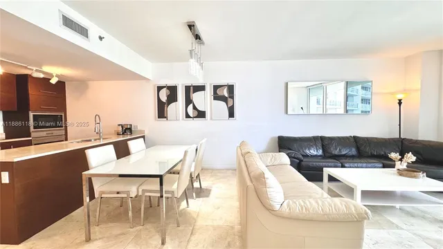 a kitchen with a table chairs and wooden floor