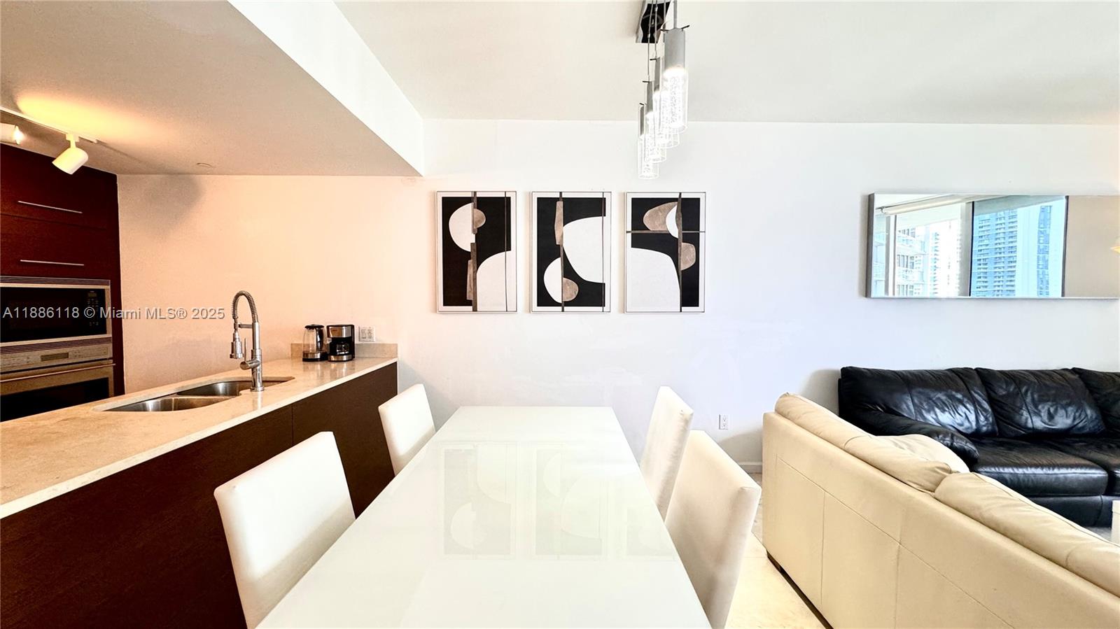 475 Brickell Avenue, Unit 2512 Miami, FL 33131 - Photo 26 of 59 a living room with furniture and wall paintings