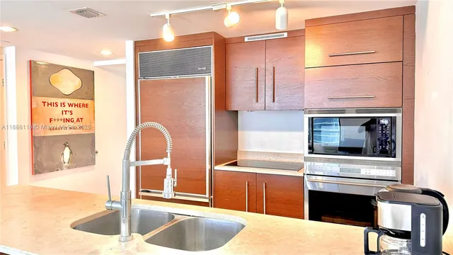 a large white kitchen with a large window