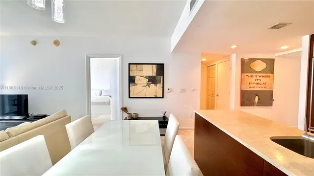 a bathroom with a granite countertop sink a mirror and a bathtub