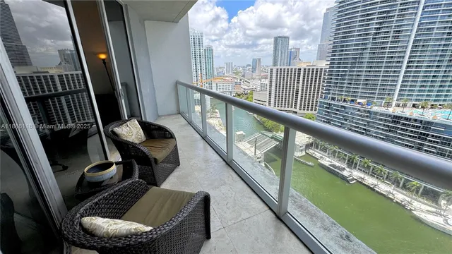 a balcony with couch and city view