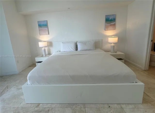 a bedroom with a bed and a view of bathroom