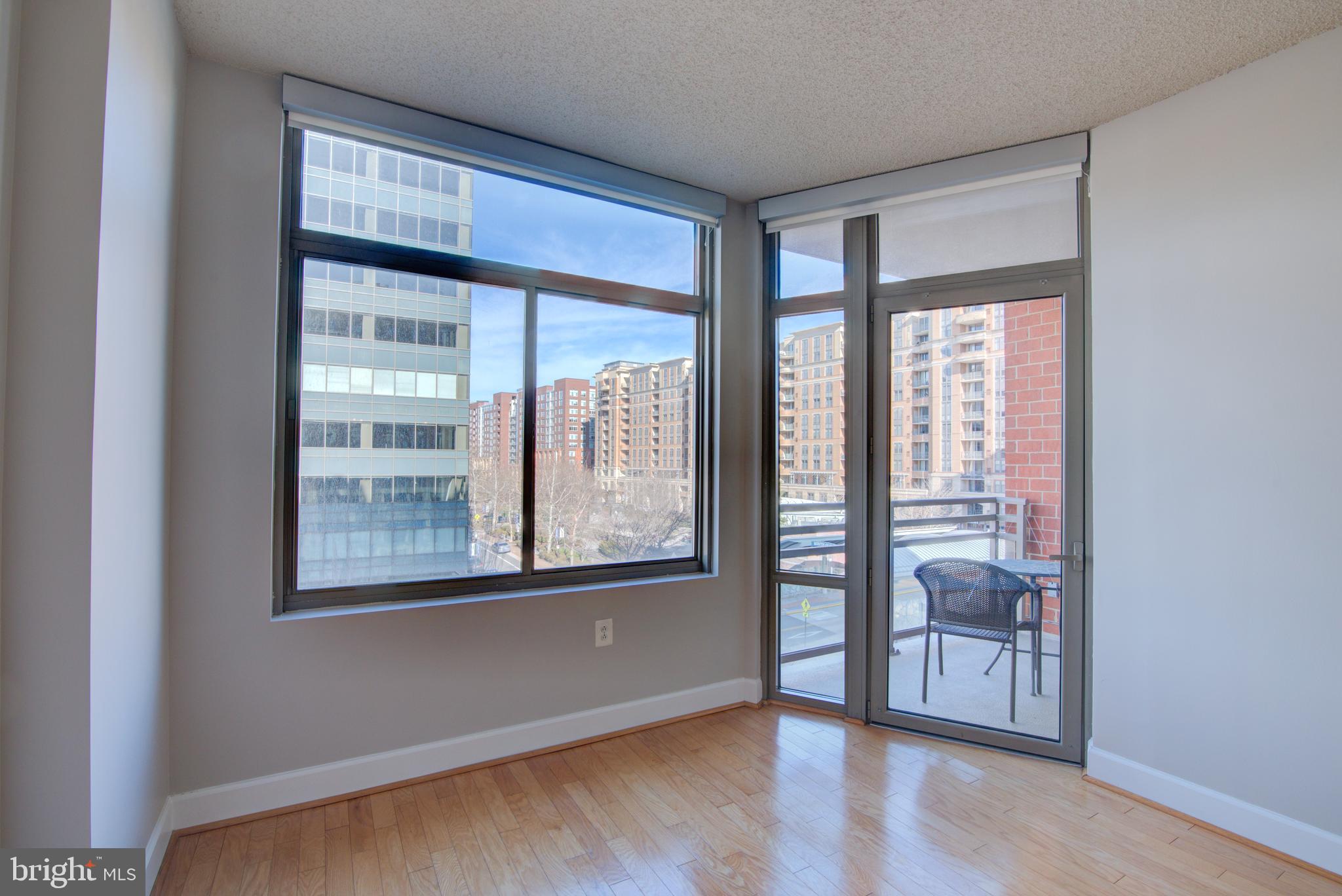 3600 South Glebe Road, Unit 414W Arlington, VA 22202 - Photo 12 of 28 a view of an empty room with a window and wooden floor