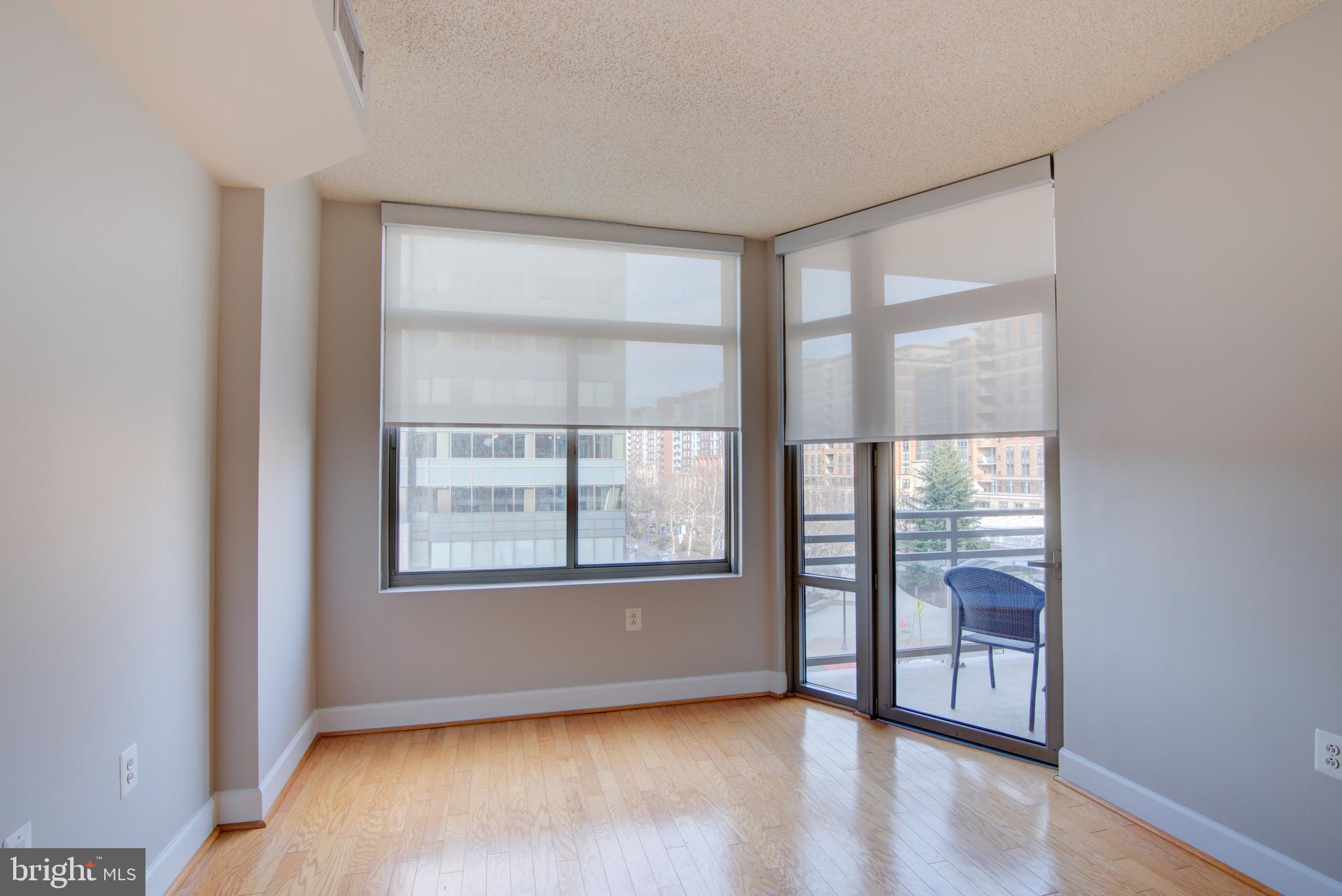 3600 South Glebe Road, Unit 414W Arlington, VA 22202 - Photo 13 of 28 an empty room with wooden floor and windows