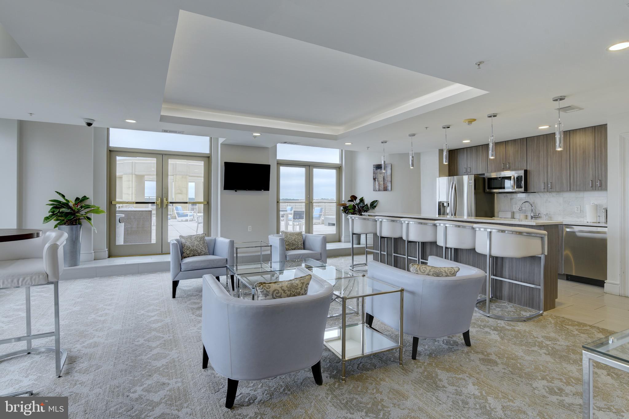 3600 South Glebe Road, Unit 414W Arlington, VA 22202 - Photo 19 of 28 a living room with couches a coffee table and kitchen view with wooden floor