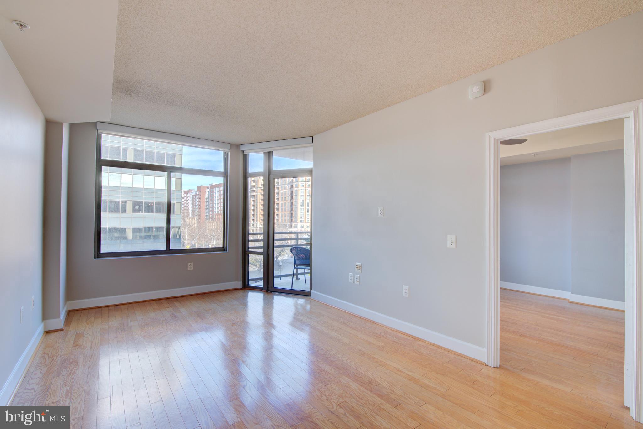 3600 South Glebe Road, Unit 414W Arlington, VA 22202 - Photo 3 of 28 an empty room with wooden floor and windows