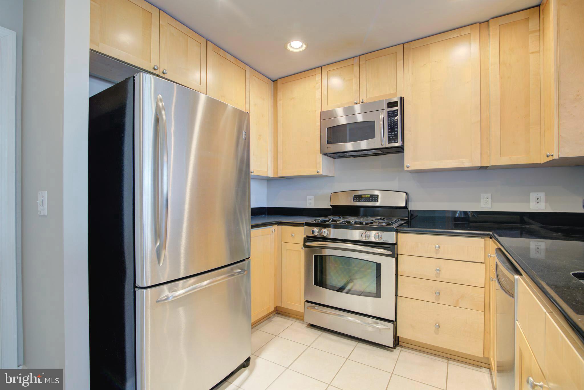 3600 South Glebe Road, Unit 414W Arlington, VA 22202 - Photo 6 of 28 a kitchen with stainless steel appliances granite countertop a refrigerator sink and stove