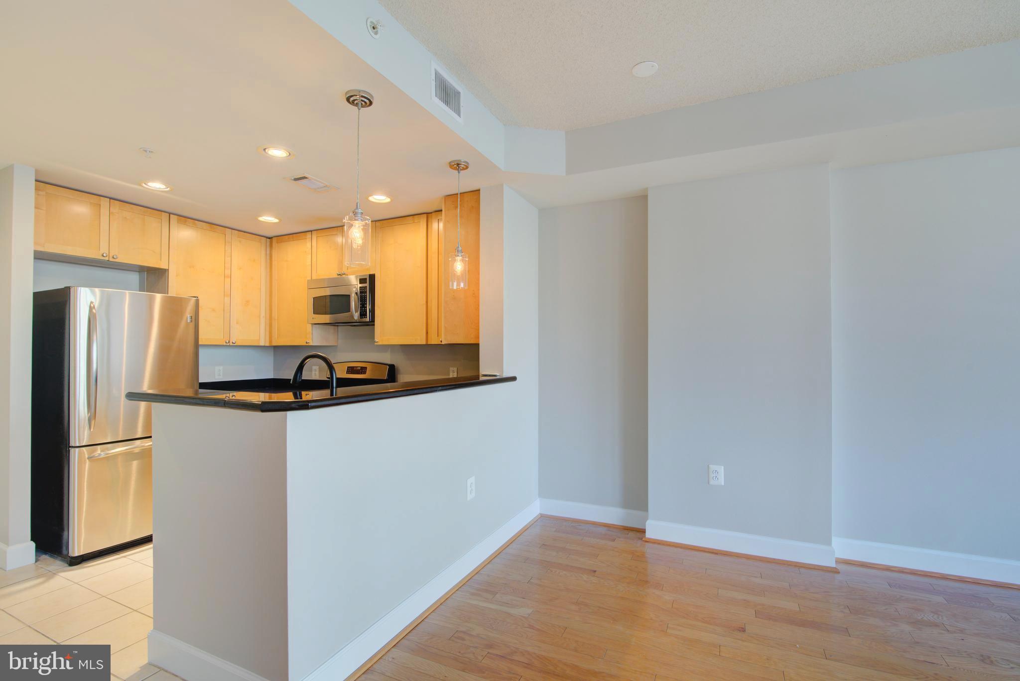 3600 South Glebe Road, Unit 414W Arlington, VA 22202 - Photo 7 of 28 a kitchen with stainless steel appliances granite countertop a refrigerator and a stove top oven