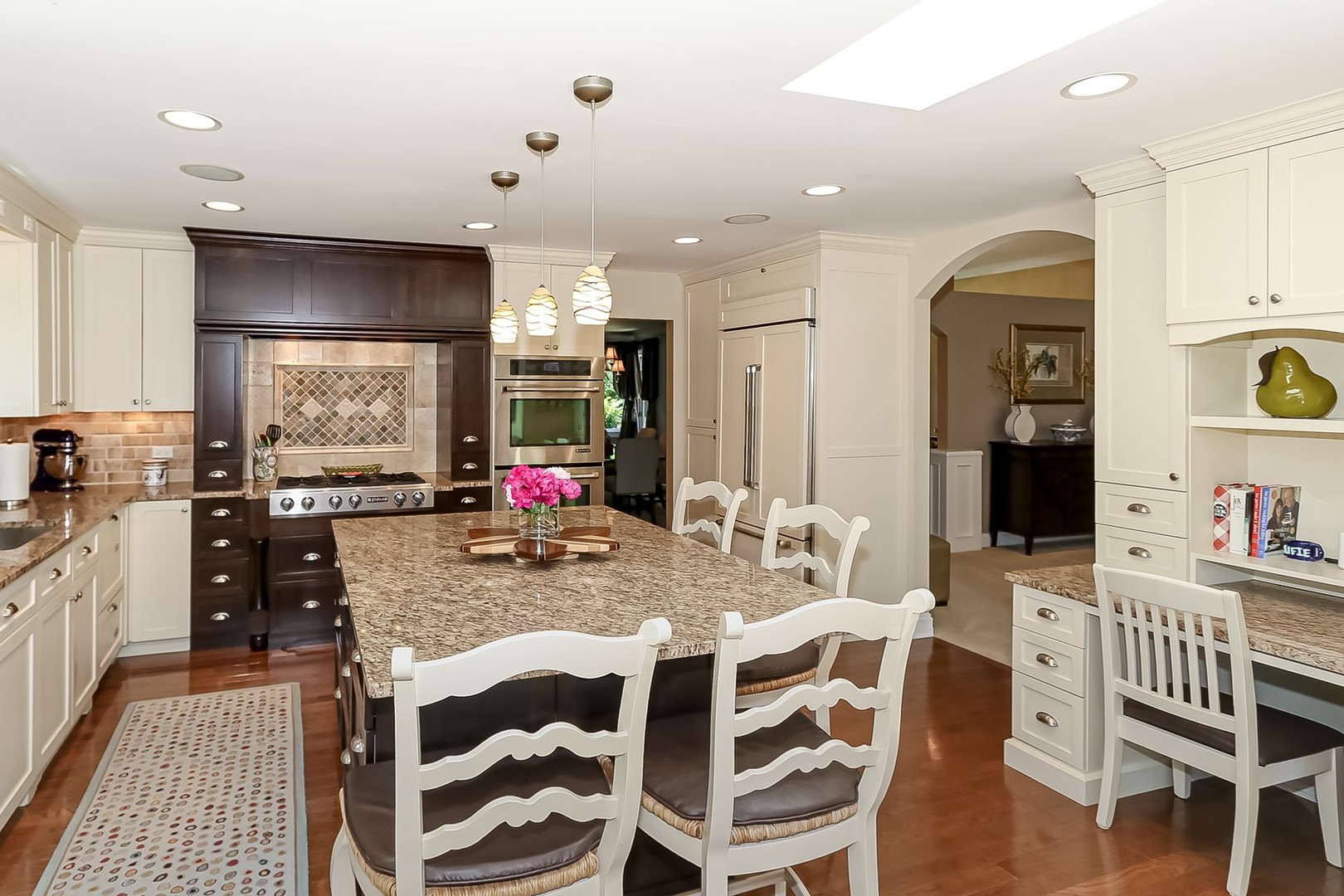 1117 Old Colony Road Lake Forest, IL 60045 - Photo 18 of 45 a kitchen with stainless steel appliances granite countertop a kitchen island a table and chairs