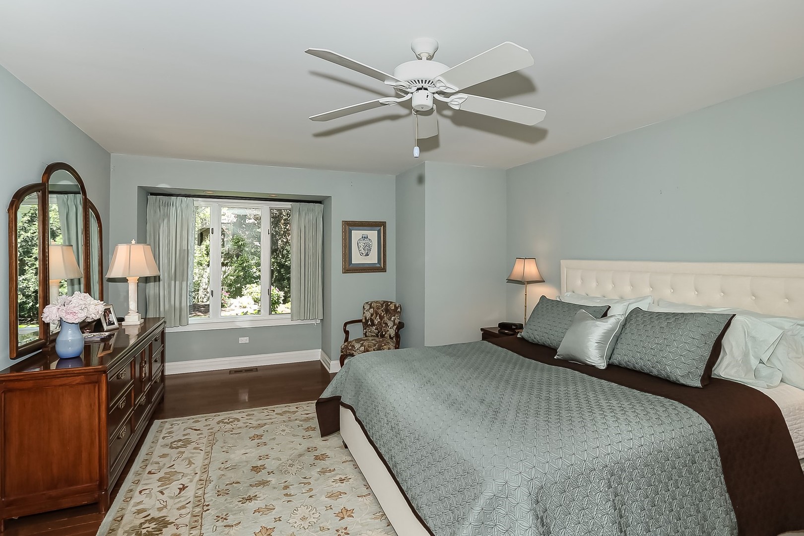 1117 Old Colony Road Lake Forest, IL 60045 - Photo 21 of 45 a bedroom with a bed and a chandelier