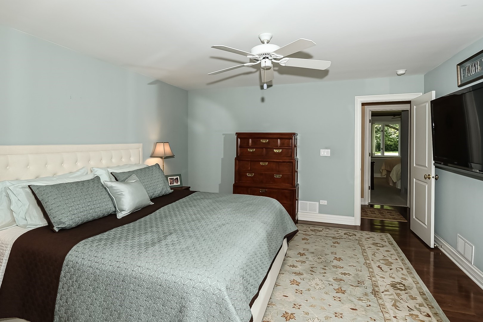 1117 Old Colony Road Lake Forest, IL 60045 - Photo 22 of 45 a bedroom with a bed and a flat tv screen on dresser