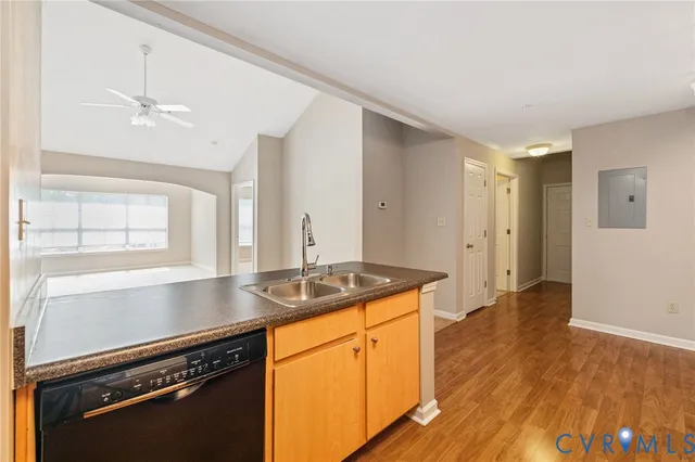 a kitchen with a sink appliances and cabinets