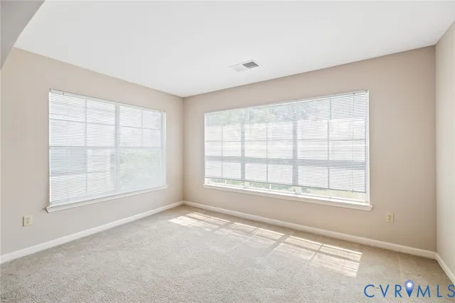 an empty room with a empty space and windows