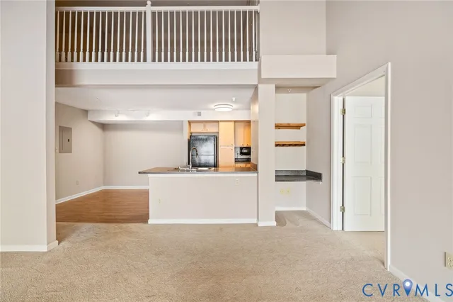 a view of kitchen with refrigerator and window
