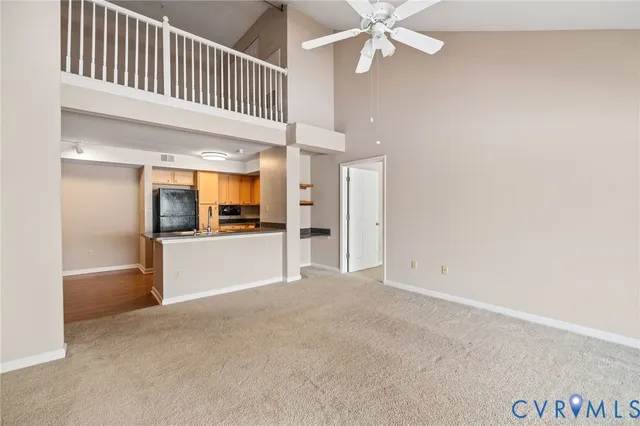 an empty room with chandelier fan