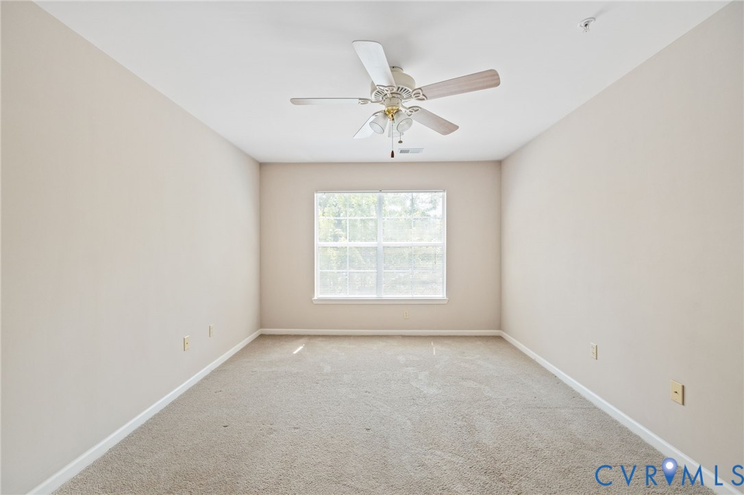 600 Fern Meadow Loop, Unit 308 Midlothian, VA 23114 - Photo 23 of 39 an empty room with a window and a ceiling fan
