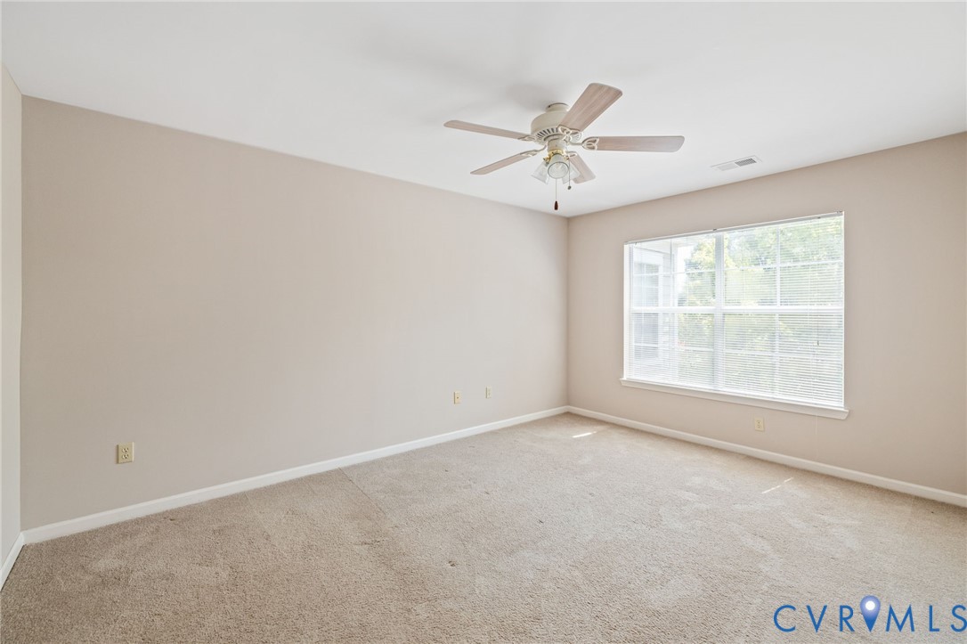 600 Fern Meadow Loop, Unit 308 Midlothian, VA 23114 - Photo 24 of 39 an empty room with a window and a fan