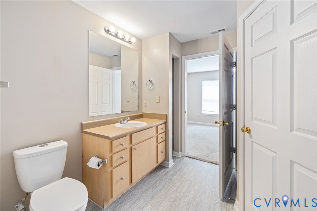 600 Fern Meadow Loop, Unit 308 Midlothian, VA 23114 - Photo 28 of 39 a bathroom with a toilet sink and mirror