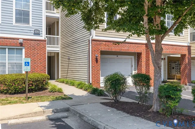 a front view of a house with plants