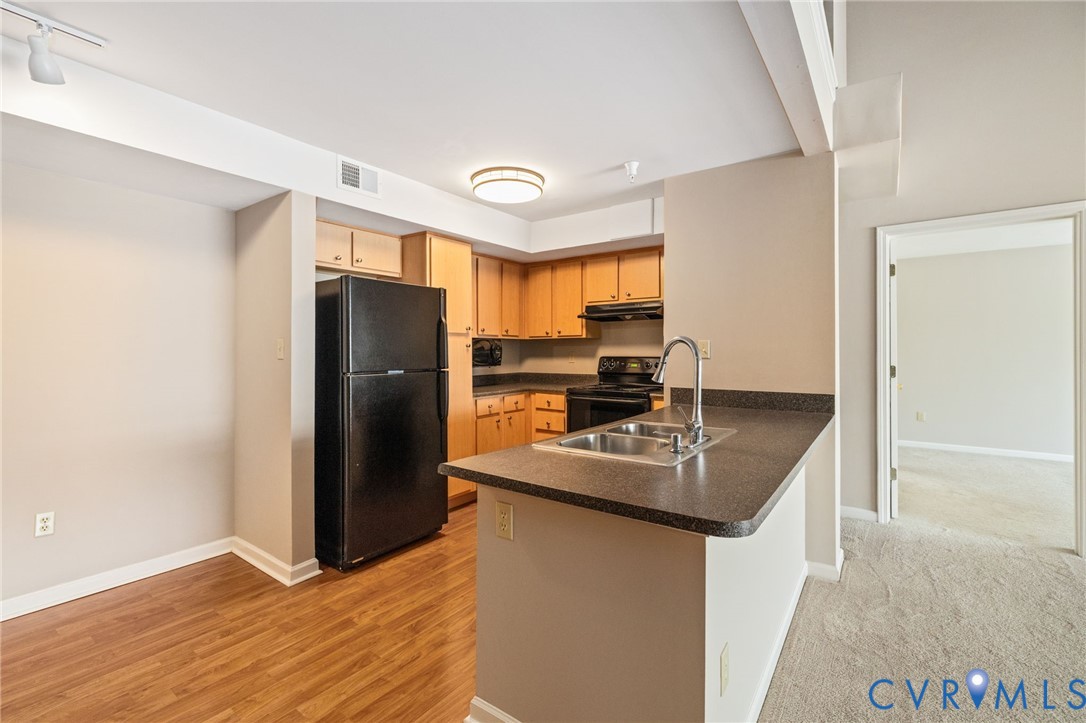 600 Fern Meadow Loop, Unit 308 Midlothian, VA 23114 - Photo 10 of 39 a kitchen with stainless steel appliances granite countertop a refrigerator a sink a stove a microwave and island