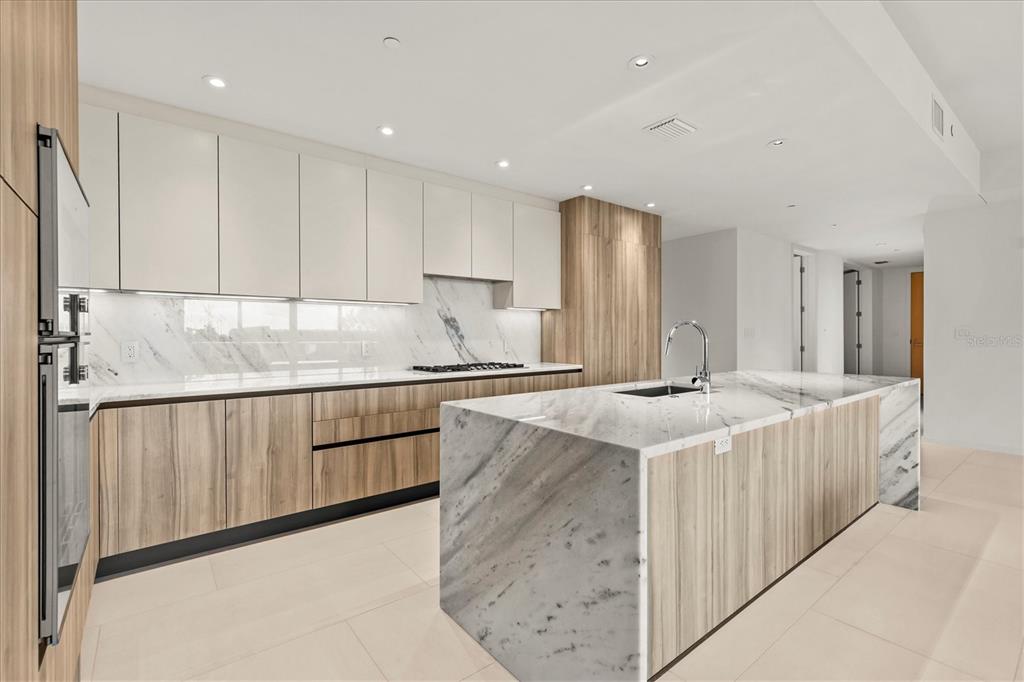 1020 Sunset Point Road, Unit 108 Clearwater, FL 33755 - Photo 11 of 62 a kitchen with stainless steel appliances granite countertop a sink and a stove