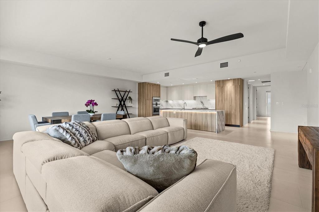 1020 Sunset Point Road, Unit 108 Clearwater, FL 33755 - Photo 12 of 62 a living room with furniture and a ceiling fan