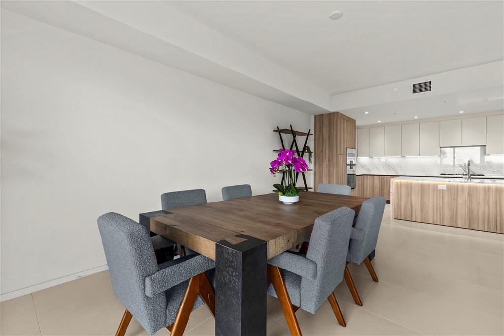 1020 Sunset Point Road, Unit 108 Clearwater, FL 33755 - Photo 13 of 62 a view of a dining room with furniture and wooden floor