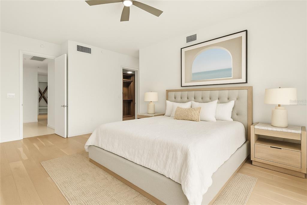 1020 Sunset Point Road, Unit 108 Clearwater, FL 33755 - Photo 15 of 62 a bedroom with a bed and a painting on the wall