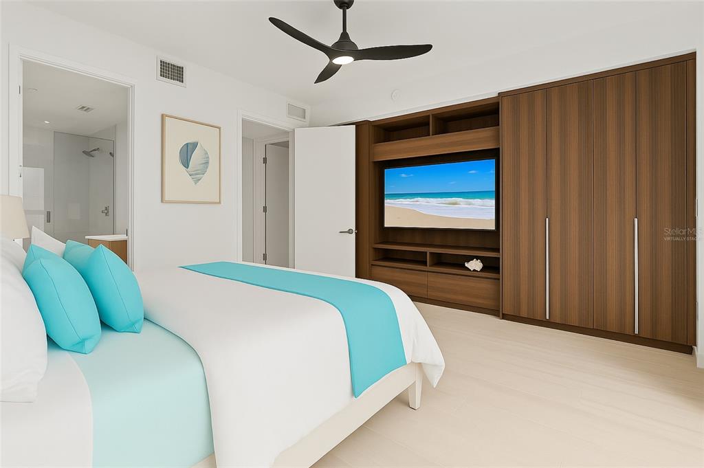 1020 Sunset Point Road, Unit 108 Clearwater, FL 33755 - Photo 19 of 62 a bedroom with a bed and a flat screen tv