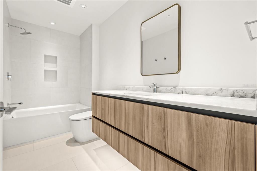 1020 Sunset Point Road, Unit 108 Clearwater, FL 33755 - Photo 22 of 62 a bathroom with a sink a toilet and shower