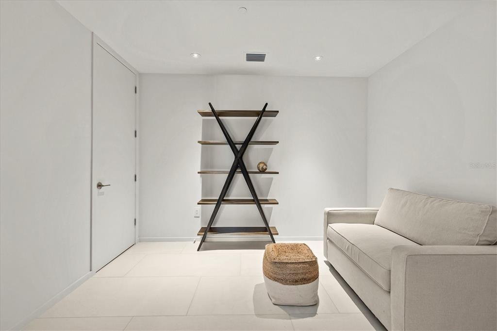 1020 Sunset Point Road, Unit 108 Clearwater, FL 33755 - Photo 24 of 62 a living room with a couch and white walls