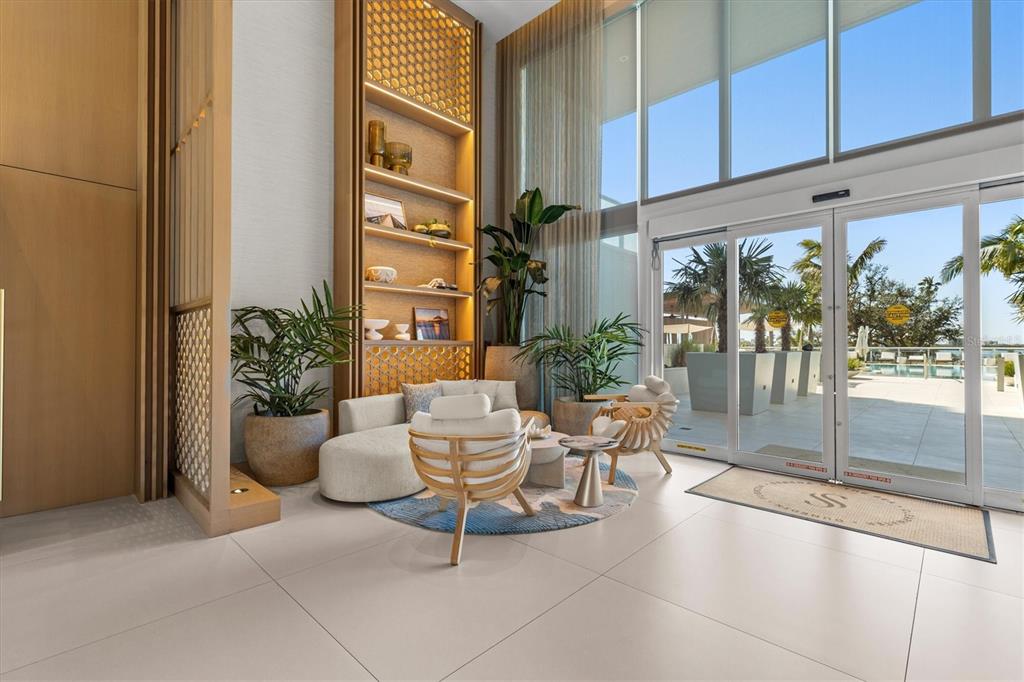 1020 Sunset Point Road, Unit 108 Clearwater, FL 33755 - Photo 34 of 62 a view of a patio with couple of chairs and a potted plant