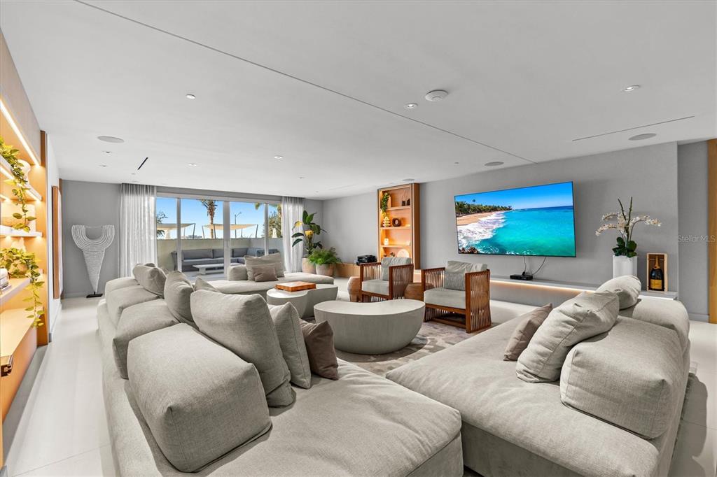 1020 Sunset Point Road, Unit 108 Clearwater, FL 33755 - Photo 35 of 62 a living room with furniture and a flat screen tv