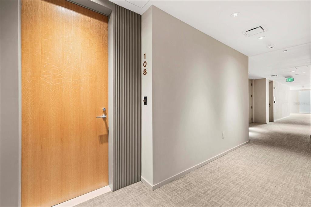 1020 Sunset Point Road, Unit 108 Clearwater, FL 33755 - Photo 5 of 62 a view of a hallway with a bathroom