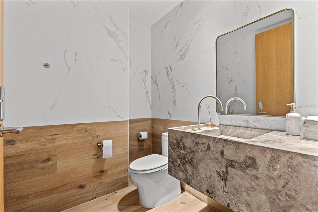 1020 Sunset Point Road, Unit 108 Clearwater, FL 33755 - Photo 52 of 62 a bathroom with a toilet sink and mirror