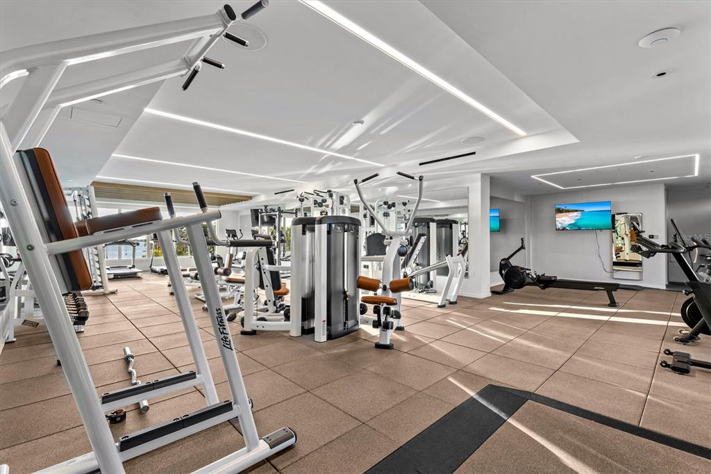1020 Sunset Point Road, Unit 108 Clearwater, FL 33755 - Photo 59 of 62 a view of a room with gym equipment